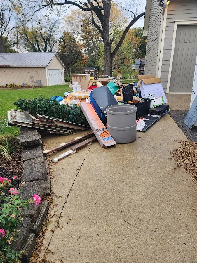 Dumpster being loaded with debris for 12 Yard Dumpster Rental in Moore